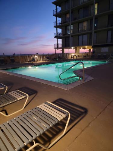 a swimming pool in front of a building at Living the Dream 2 Bedroom Ocean View Cozy Condo in Gulf Shores