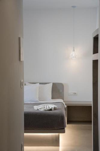 a bedroom with a bed with a white wall at Anna's in Karterados