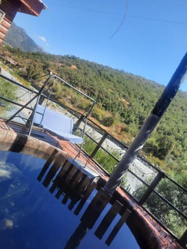 a view from the top of a pool with a mountain in the background at Los queñes Country House in Los Queñes