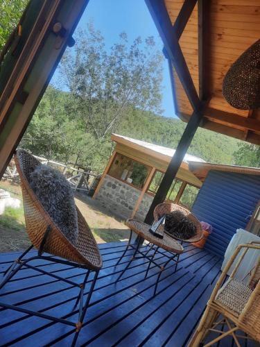 two chairs sitting on a deck in a cabin at Los queñes Country House in Los Queñes