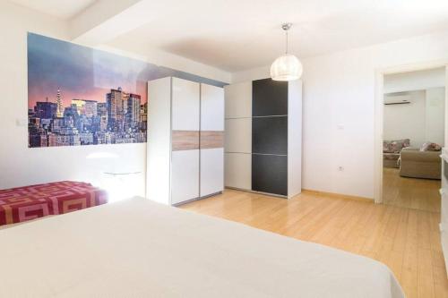a bedroom with a bed and a painting on the wall at Vita Garden Apartment 85 m2 Private Entrance & 100 m2 Terrace in Pula