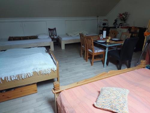 Habitación con 2 camas, mesa y sillas en B&B de (S)tulp en Retie