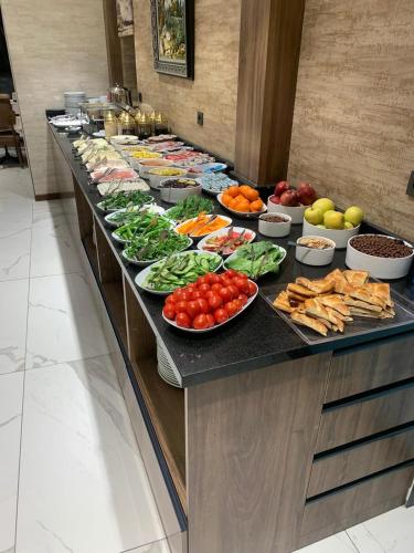 a buffet line with plates of vegetables and other foods at Özkaya hotel in Sivas