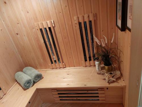 a wooden sauna with a towel and a plant in it at Studio Mañana in Cuijk