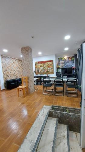 a living room with a couch and a table and chairs at Residencial Condado in Faro