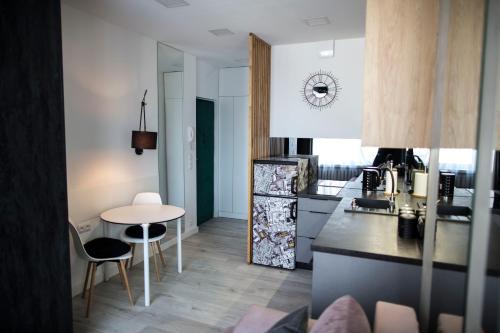 a kitchen with a table and a counter top at APARTAMENT Welurowy in Kielce