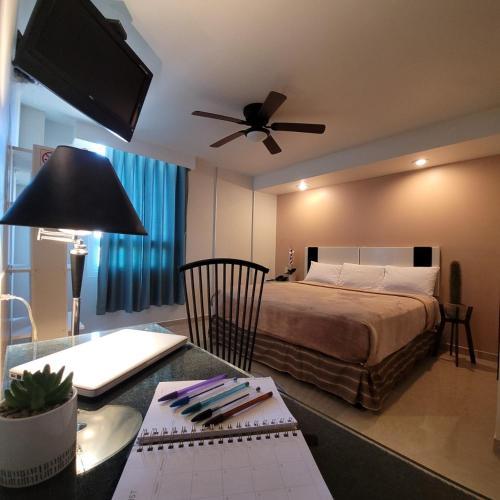 a hotel room with a bed and a desk with a computer at Hotel Cali Blvd. in Guadalupe
