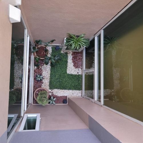 an empty balcony with plants on the wall at Hotel Cali Blvd. in Guadalupe