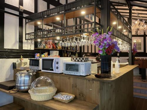 a kitchen with a counter with microwaves and flowers on it at Hakuba Sun Valley Hotel Annex - Vacation STAY 90355v in Iida