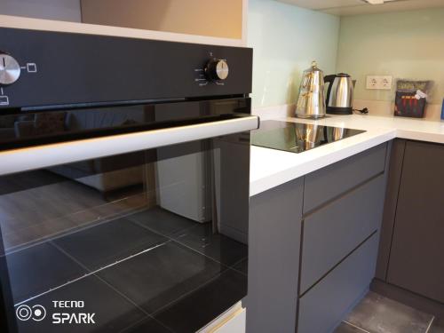 a kitchen with a black oven in a kitchen at Mali Garden Residence in Side