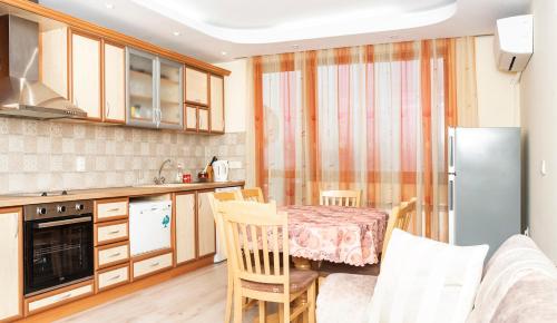 a kitchen with a table and chairs in a room at Явор in Tryavna