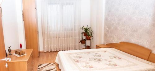 a bedroom with a bed and a window at Явор in Tryavna