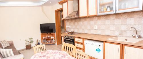 a kitchen with a sink and a counter top at Явор in Tryavna