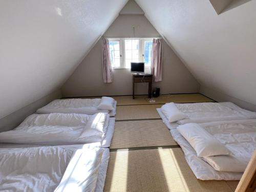 A bed or beds in a room at Hakuba Sun Valley Hotel Annex - Vacation STAY 90344v