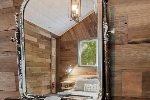a mirror in a sauna with a bench and a window at Sydneys River Retreat in Guerneville