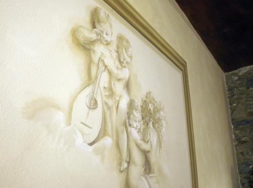 a painting of a woman playing a instrument and a child at Pietre di Mare in Monterosso al Mare