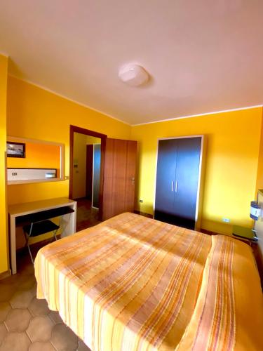 a bedroom with a large bed and a desk at Residence Hotel Felix in Ricadi