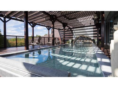 a large swimming pool in a building at Hotel Areaone Hiroshima Wing - Vacation STAY 62261v in Higashihiroshima