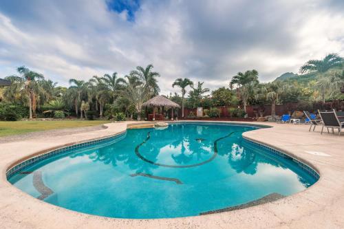 a swimming pool in a resort with a gazebo at GT - Rarotonga Fishing Lodge in Rarotonga