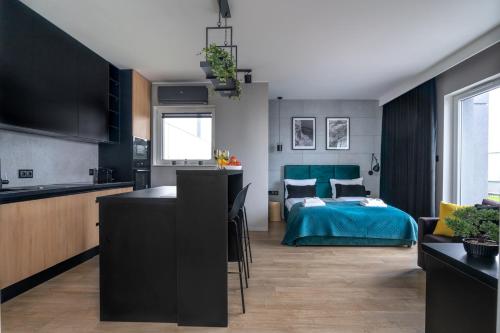 a kitchen and a living room with a bedroom at Baltica Towers by Symphony Aparthotels in Gdańsk