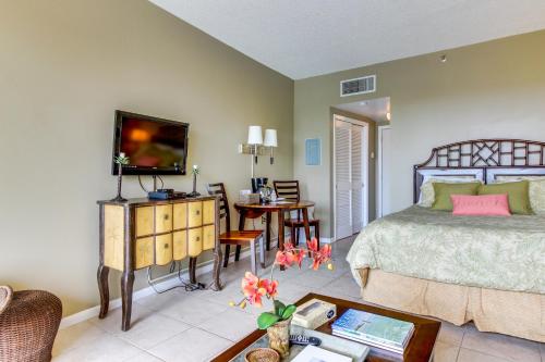 a bedroom with a bed and a tv and a table at Pirates Bay B206 in Fort Walton Beach