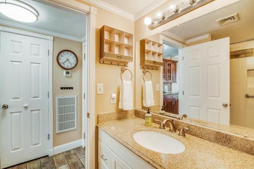 a bathroom with a sink and a mirror at Pirates Bay A113 in Fort Walton Beach