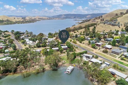 an aerial view of a town with a boat in a river at Dawn Retreat in Bonnie Doon