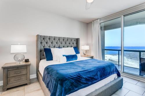 a bedroom with a bed with a view of the ocean at Portofino Island Resort Tower 2-703 in Pensacola Beach