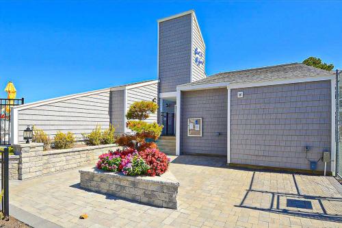 a house with a garage with flowers in front of it at East of the Sun --- 39620 E Sun Drive #715 in Fenwick Island