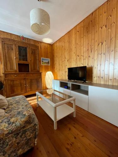 a living room with a tv and a coffee table at Nel Borgo in Verrès