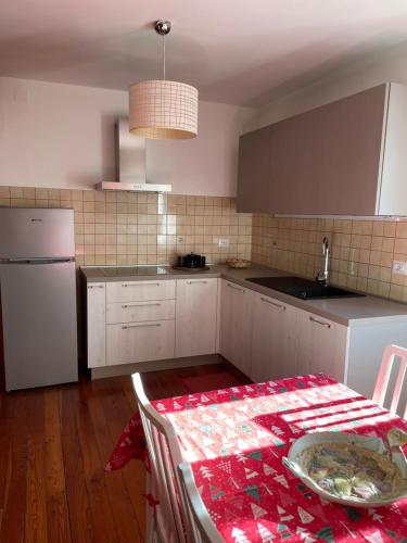 a kitchen with a table with a tablecloth on it at Nel Borgo in Verrès