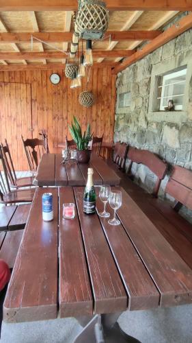 a wooden table in a cabin with wine glasses at Holiday Home Moldava in Moldava