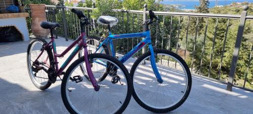 two bikes are parked next to a fence at Villa YOLO in Almirida