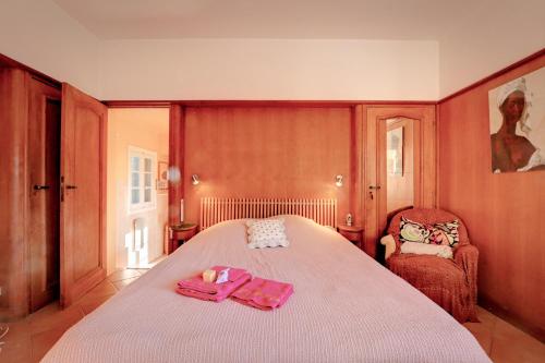 a bedroom with a bed with pink towels on it at Les Iles D'Or in Rayol-Canadel-sur-Mer