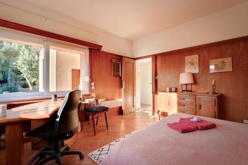 a bedroom with a desk and a computer in it at Les Iles D'Or in Rayol-Canadel-sur-Mer