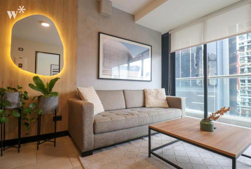 a living room with a couch and a table at Navarrete Residence in Premium San Isidro by Wynwood House in Lima