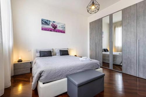 a bedroom with a large bed and a mirror at Il Loft di Vanni in Vicenza