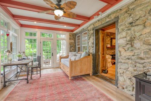 a room with a stone wall with a bed and a table at High Meadows Estate in Purcellville
