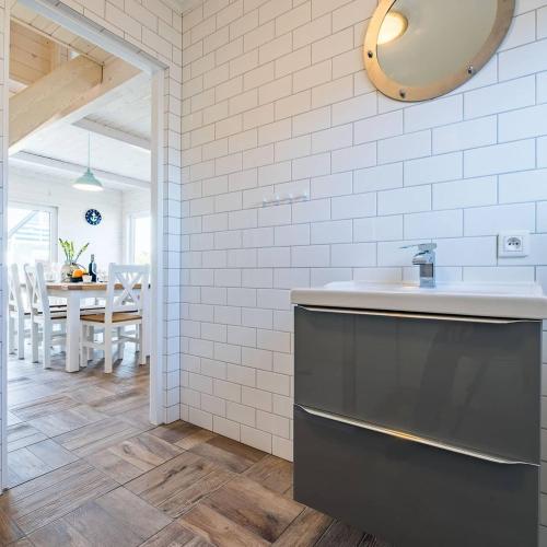 a kitchen with a sink and a dining room at Pod Morskim Niebem in Rowy