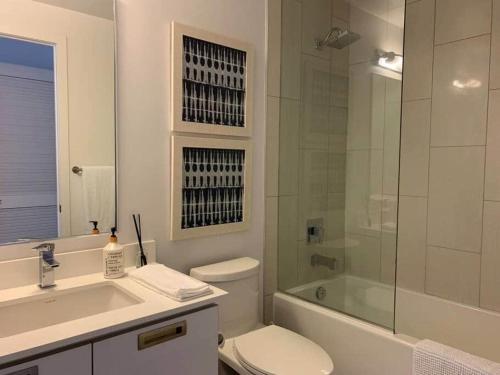 a bathroom with a toilet and a sink and a shower at Stunning Stayz At Friday Harbour Beach Marina Resort Lake Simcoe Innisfil in Innisfil