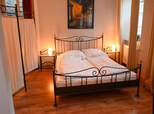 a bedroom with a bed with two candles on the floor at Haus Weihertor in Traben-Trarbach