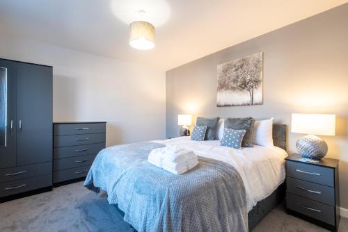 a bedroom with a large bed and two night stands at No203 in Doncaster