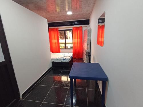a hallway with a table and a room with red curtains at Apartamento, La paz in Puerto Triunfo