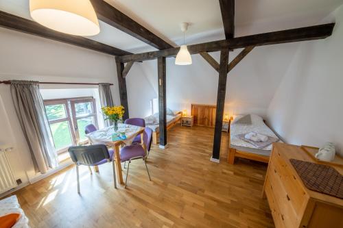 a living room with a table and chairs and a bedroom at Żywkowo Bocianie Gospodarstwo Rolne in Górowo Iławeckie