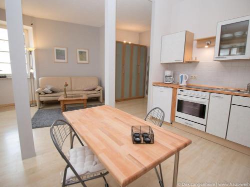a kitchen and living room with a wooden table and chairs at Haus Weihertor in Traben-Trarbach