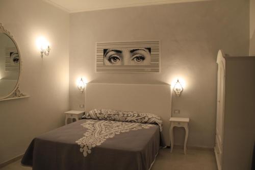 a bedroom with a bed with two eyes on the wall at Affittacamere Golfo Della Luna in La Spezia