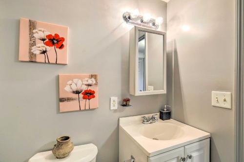 a bathroom with a sink and a toilet and a mirror at Beautiful Home with Mountain-View Deck and Smart TV in Warm Springs
