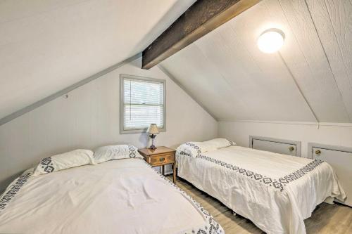 two beds in a attic bedroom with a window at Beautiful Home with Mountain-View Deck and Smart TV in Warm Springs