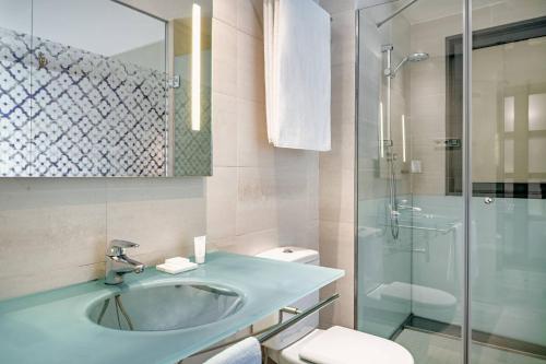 a bathroom with a sink and a toilet and a shower at AC Hotel Irla by Marriott in Barcelona
