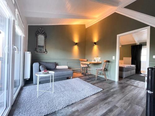 a living room with a couch and a table at Rosenhof-Lodge in Hanerau-Hademarschen